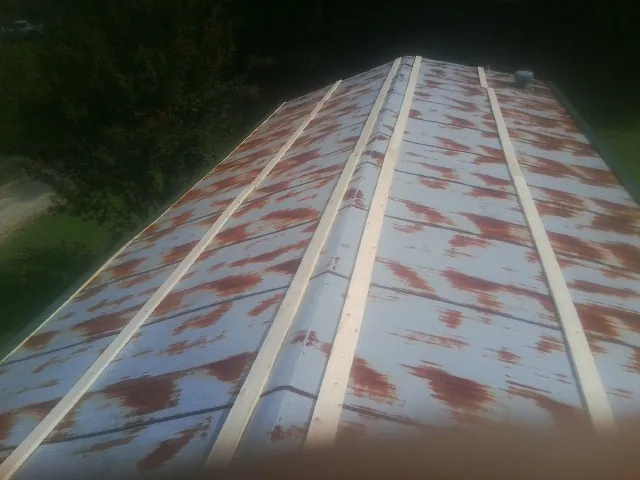 Rusted metal roof panels with new wood purlins before replacement — Storm Damage Roof Repair in Beaverdam by Roofing Brothers